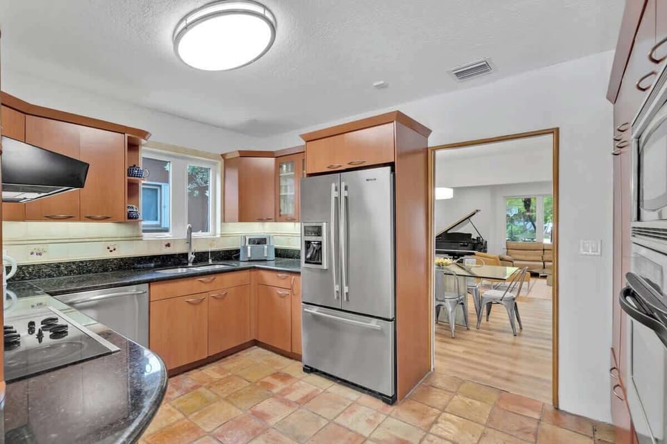 “Stay in this bright Airbnb rental with modern kitchen, cozy living area, and piano charm—perfect vacation rental for family meals, relaxation, and unforgettable getaways.”
