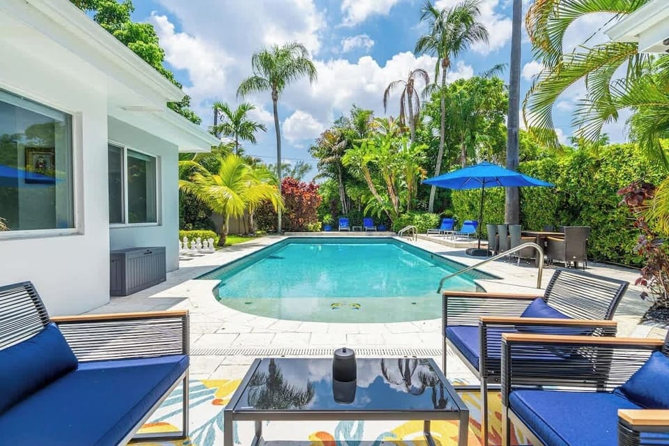 “Soak up the sun at this tropical Airbnb rental with a sparkling pool, lounge chairs, and lush palm views—perfect vacation getaway for relaxation, family fun, and unforgettable stays.”