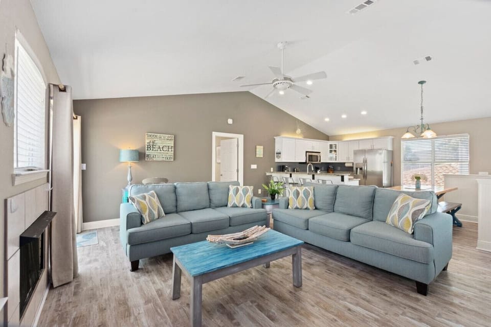 An open living room and kitchen with stunning views and plenty of natural light, creating a bright and airy space perfect for relaxing or entertaining!