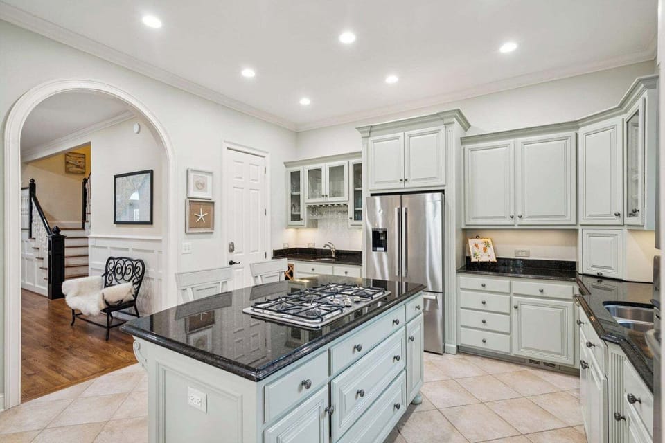 Cook your favorite meals in this elegant gourmet kitchen with granite countertops, stainless steel appliances, and ample cabinet storage for all your culinary adventures.