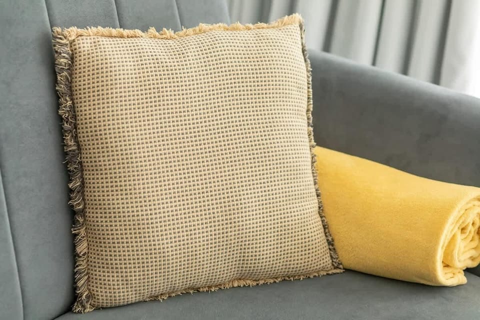 A close-up of decorative cushions placed on a sofa, adding warmth and texture to the interior.