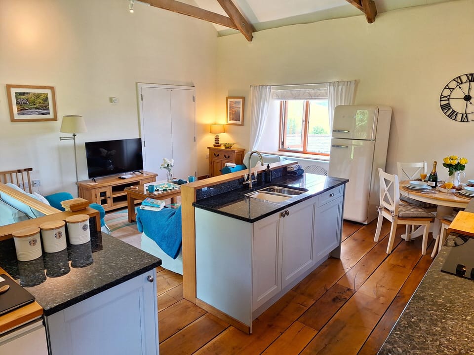 Open plan living space with solid English oak flooring