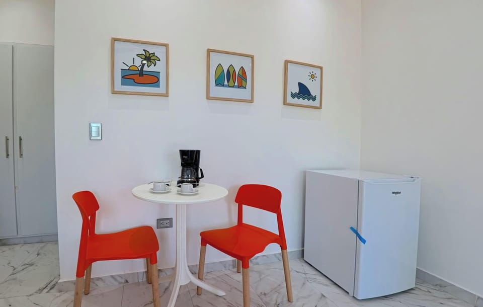 Table and two chairs, ideal for casual meals.