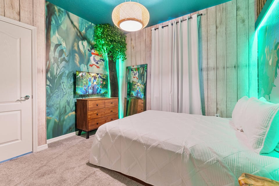 Enjoy a vibrant retreat in this uniquely designed bedroom featuring a colorful mural and warm wooden paneling. The cozy white bedding invites relaxation, complemented by illuminated accents that create a playful atmosphere.