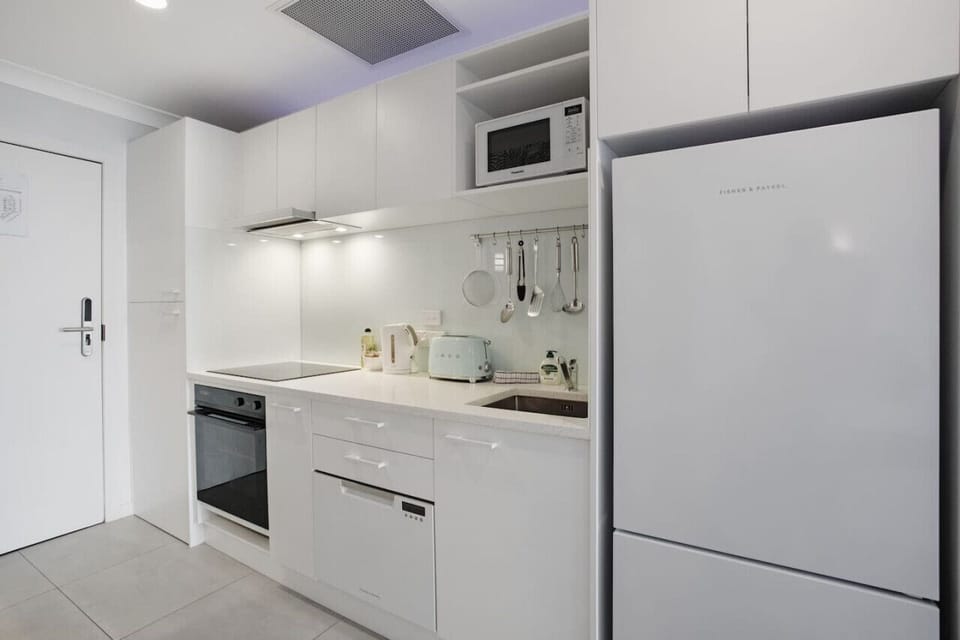 The kitchen has everything you need to cook, including an oven, cooktop, dishwasher, fridge/freezer, and microwave.