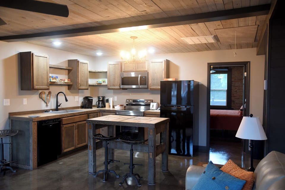 Kitchen contains hand crafted counter tops, island and shelving.