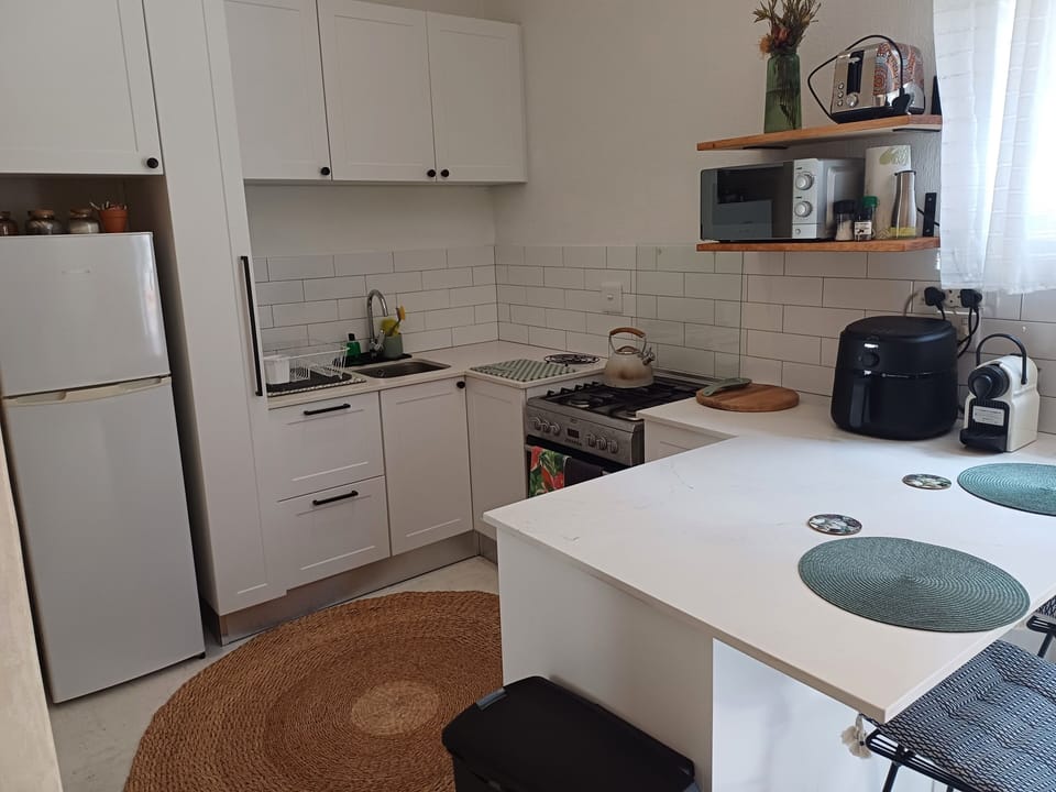 Kitchen with gas stove, microwave, toaster and air fryer