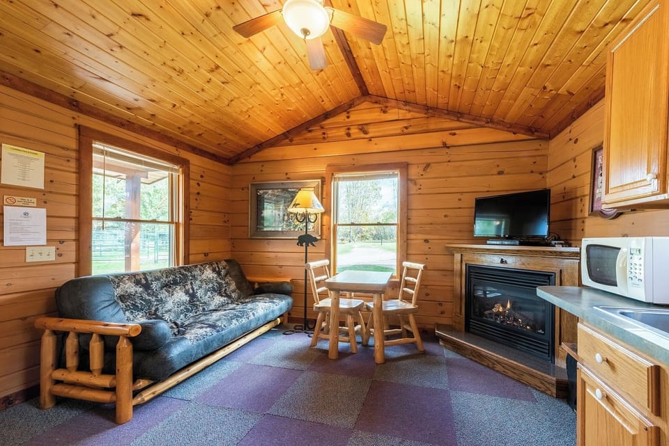 Living Space

The living space has a nice table and chairs to enjoy a quick meal before you head out on your daily adventure.  

The futon couch does fold down into a double bed.   The Ranch does provide the bedding!  