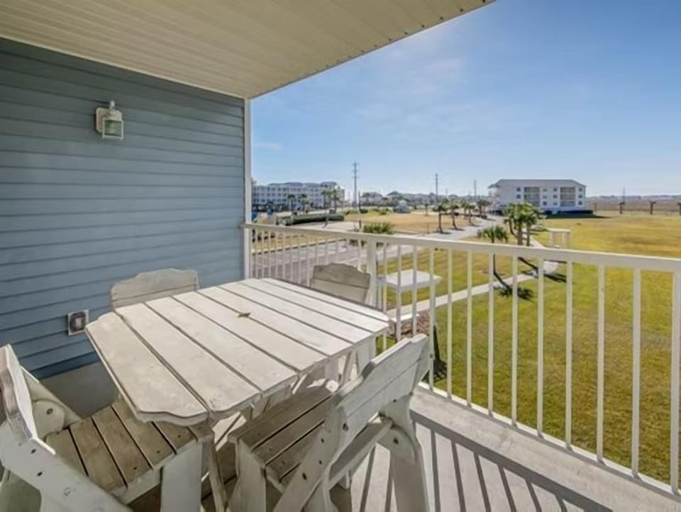 Savor your morning coffee on the private balcony, where a rustic table welcomes sunny days and gentle breezes