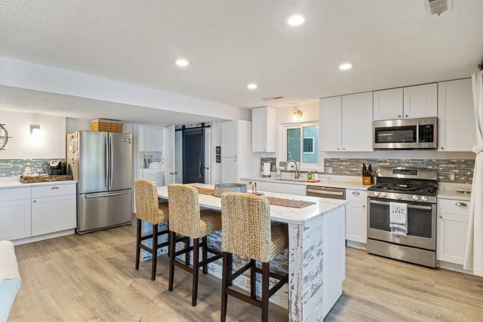 Modern kitchen with stainless steel appliances and a spacious island.