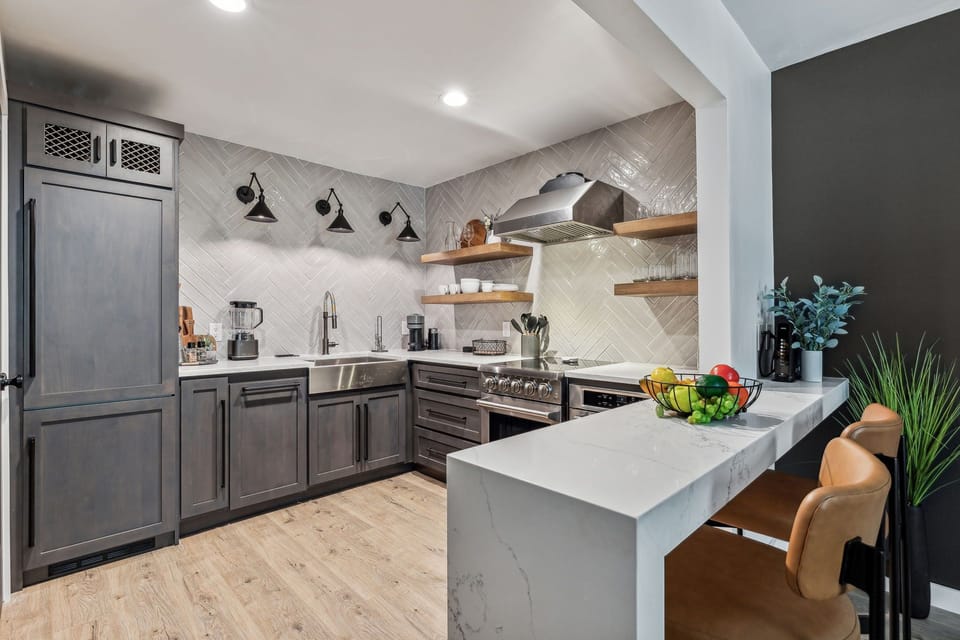 Fully equipped kitchen boasting stainless steel appliances and stocked with all culinary essentials.