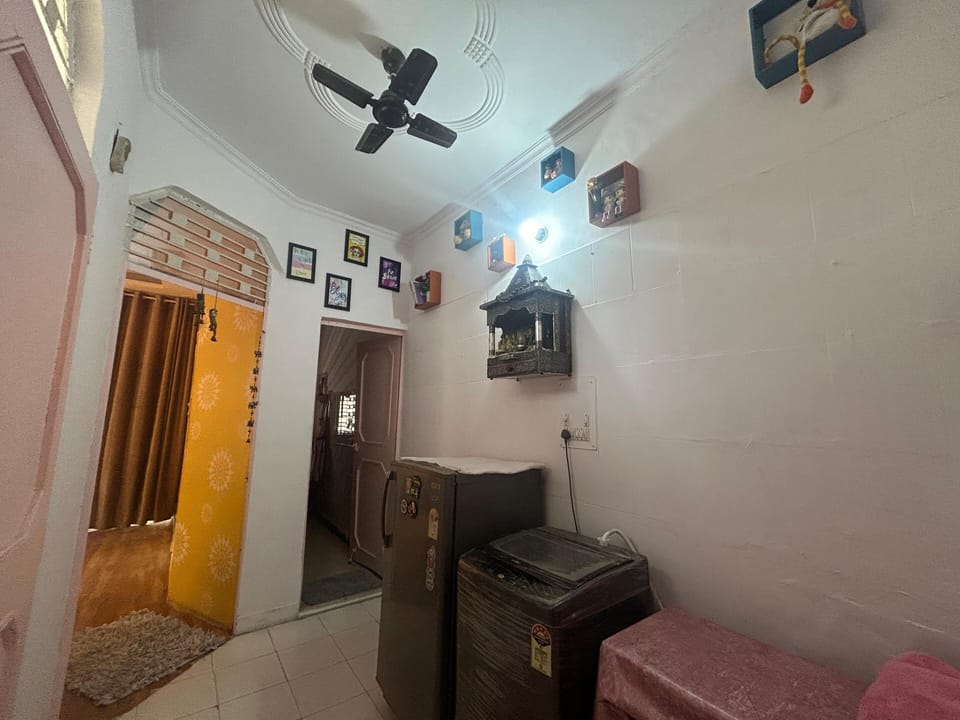 living area, washing machine, laundry area, washing cloths, fridge
