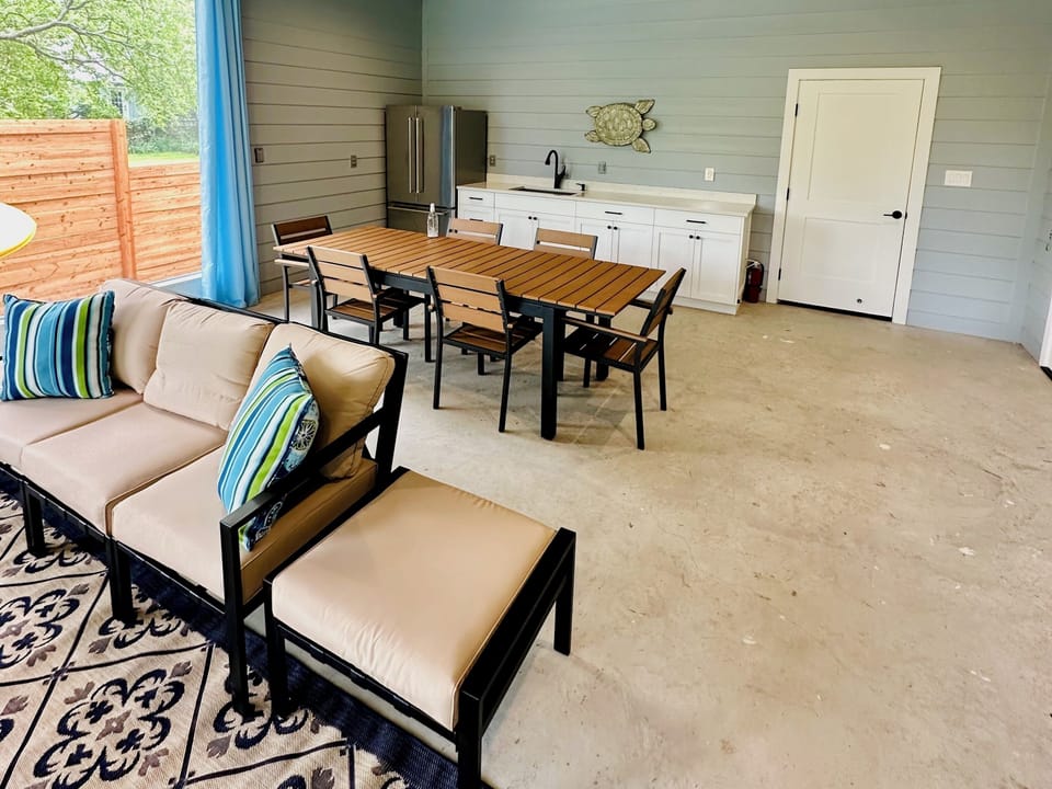 Large screened living / dining room with TV, refrigerator and full bathroom.