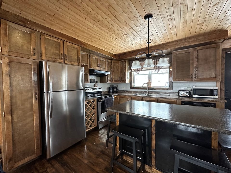 Fully stocked kitchen with fridge, stove, dishwasher, microwave.