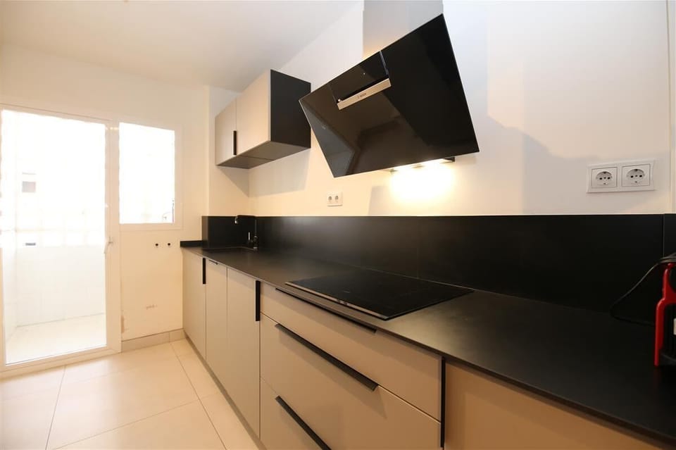 Fully-equipped kitchen with laundry room to the rear