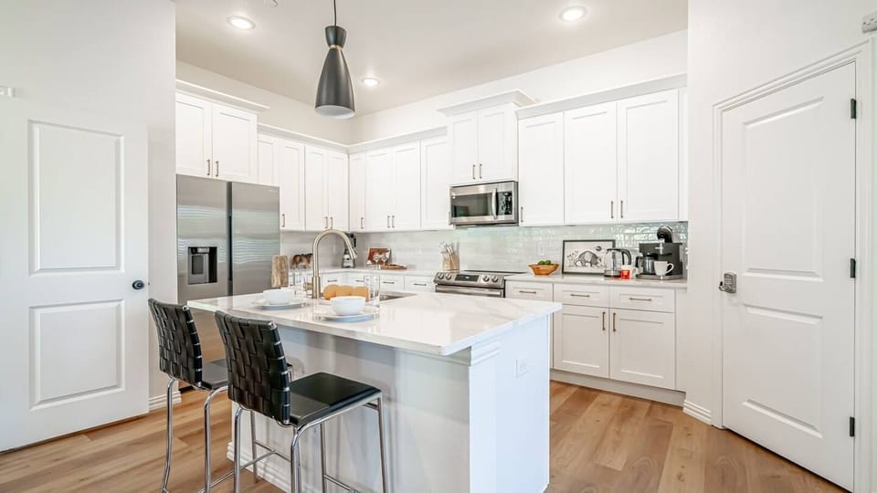 A breakfast table with two sleek bar stools invites you to savor your morning brew.