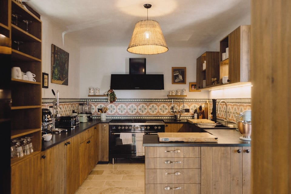 Overview of Villa's kitchen, with a gas stove, natural wood accents. 