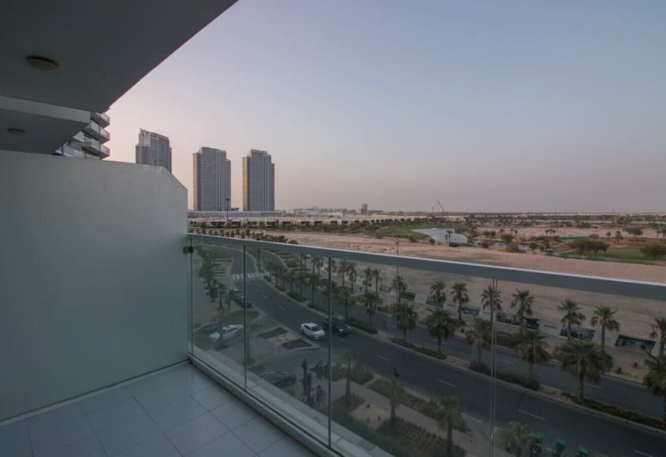 Expansive balcony view of the city skyline & palm-lined streets stretching into the distance.