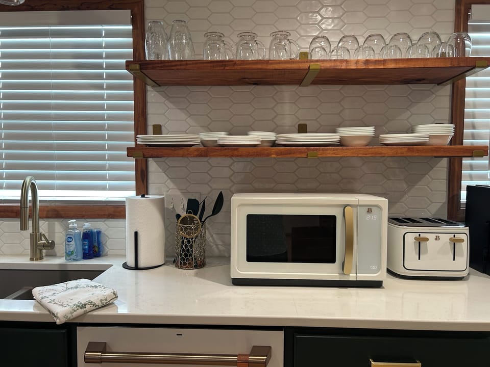 Microwave, 4 slot toaster, and openshelving makes finding dinnerware a breeze.