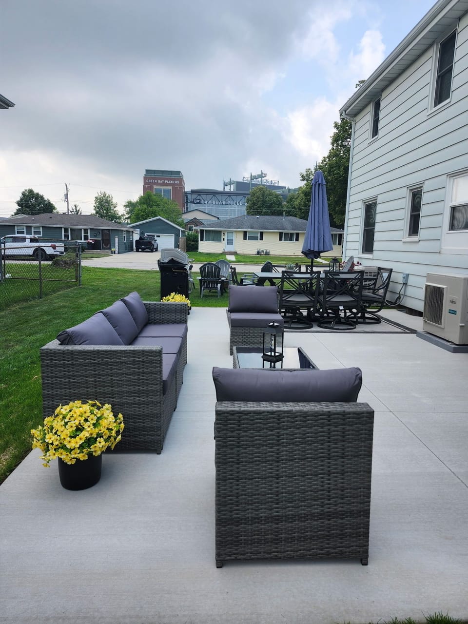 New, large cement patio has comfy sectional, large patio table & view of Lambeau