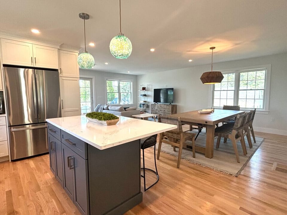 Beautiful open concept downstairs.  Couch, TV, farm house table and a spacious kitchen
