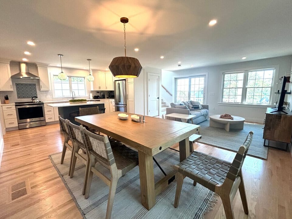 Beautiful open concept downstairs.  Couch, TV, farm house table and a spacious kitchen