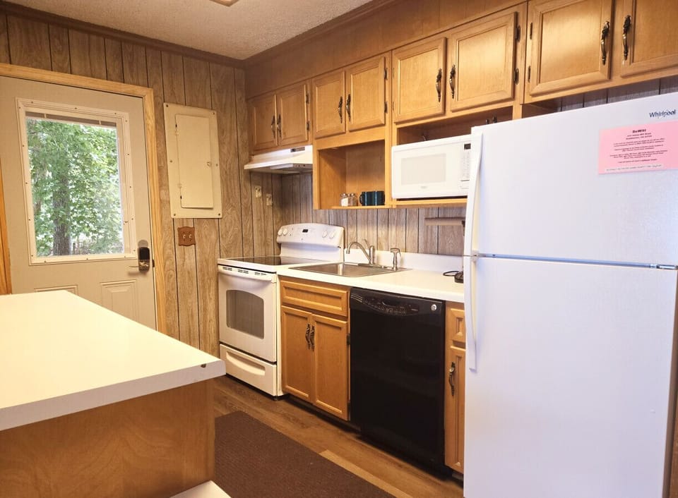 Bright, small kitchen with essentials for cooking dinner.