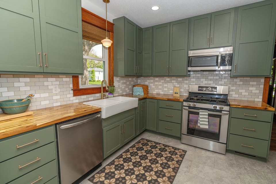 completely renovated kitchen featuring custom cabinets and butcherblock counters
