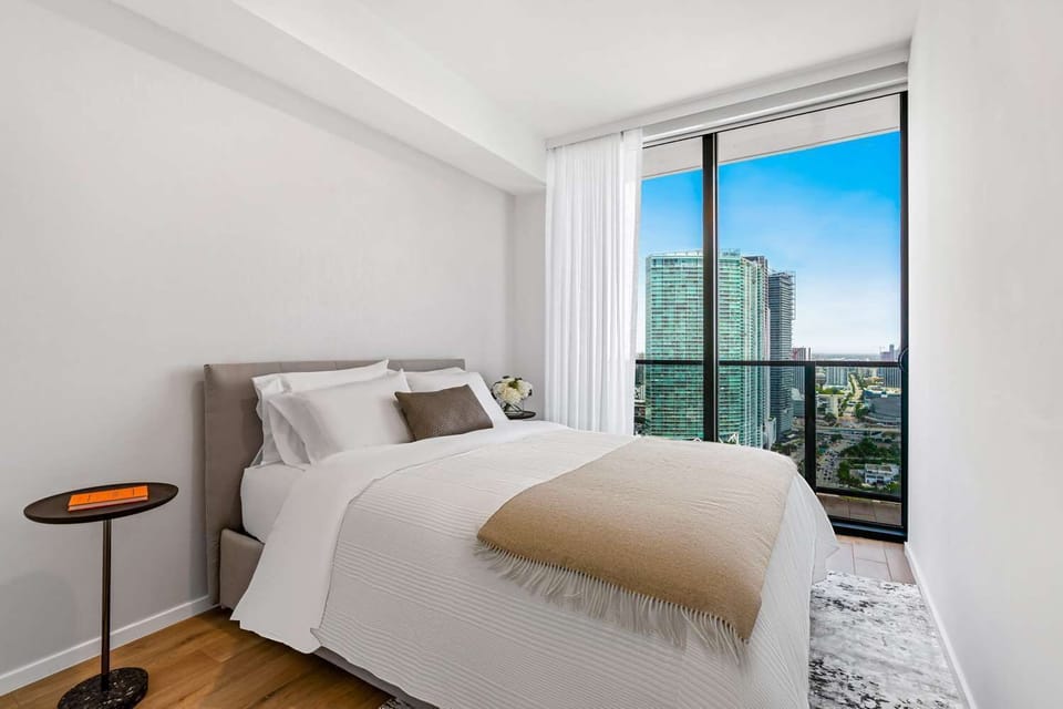 Drift off with skyline views and crisp hotel linens.