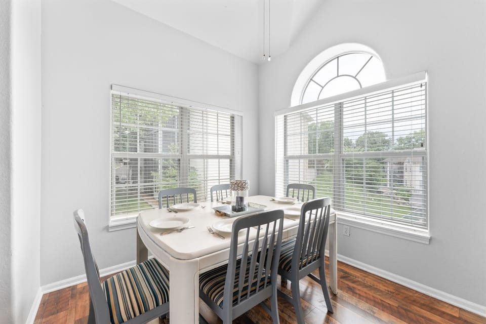 Dine with a view—our stylish dining area features large windows showcasing the lush greenery outside.