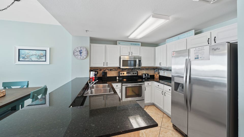 Your spacious kitchen features granite countertops, stainless steel appliances, and everything you need to create memorable vacation meals.