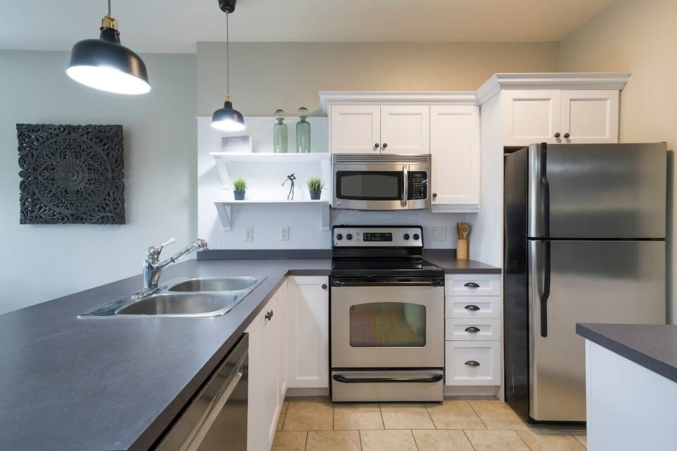 Fully equipped kitchen with stainless steel appliances. 
