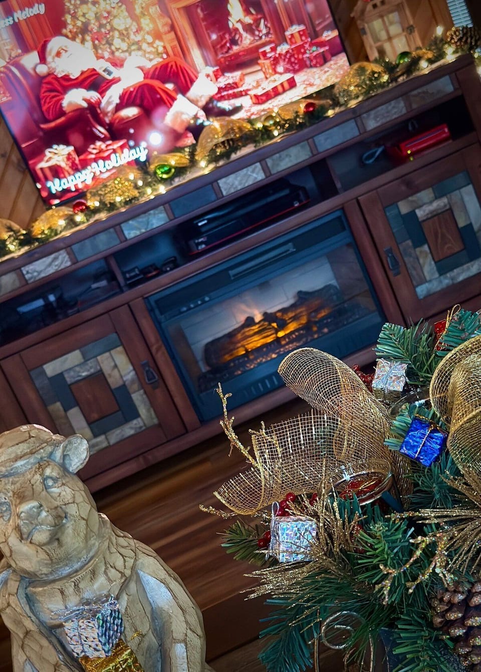 Festive decor on a modern fireplace mantel in the common area.