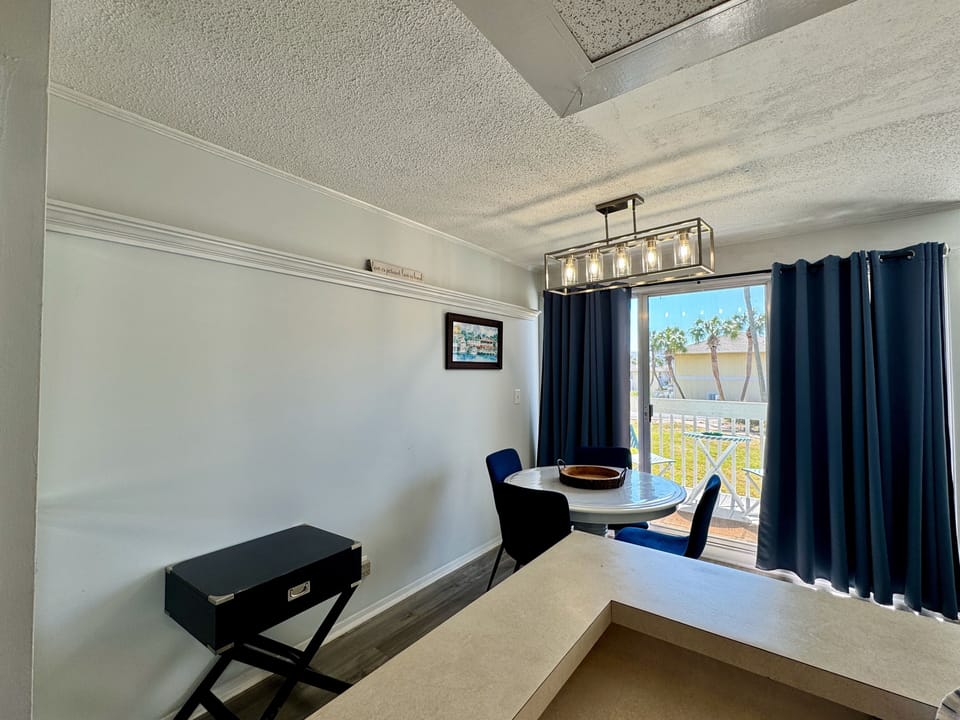 Your stylish dining space features a round table perfect for meals, with natural light streaming through to your private balcony.