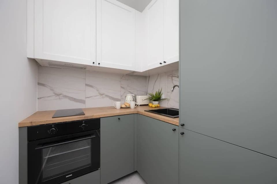 The sleek design of the kitchenette blending seamlessly with the living area.