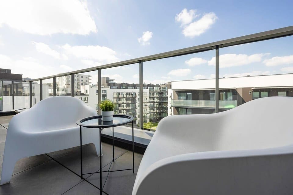 The furnished balcony offers a perfect spot for morning coffee with a view.