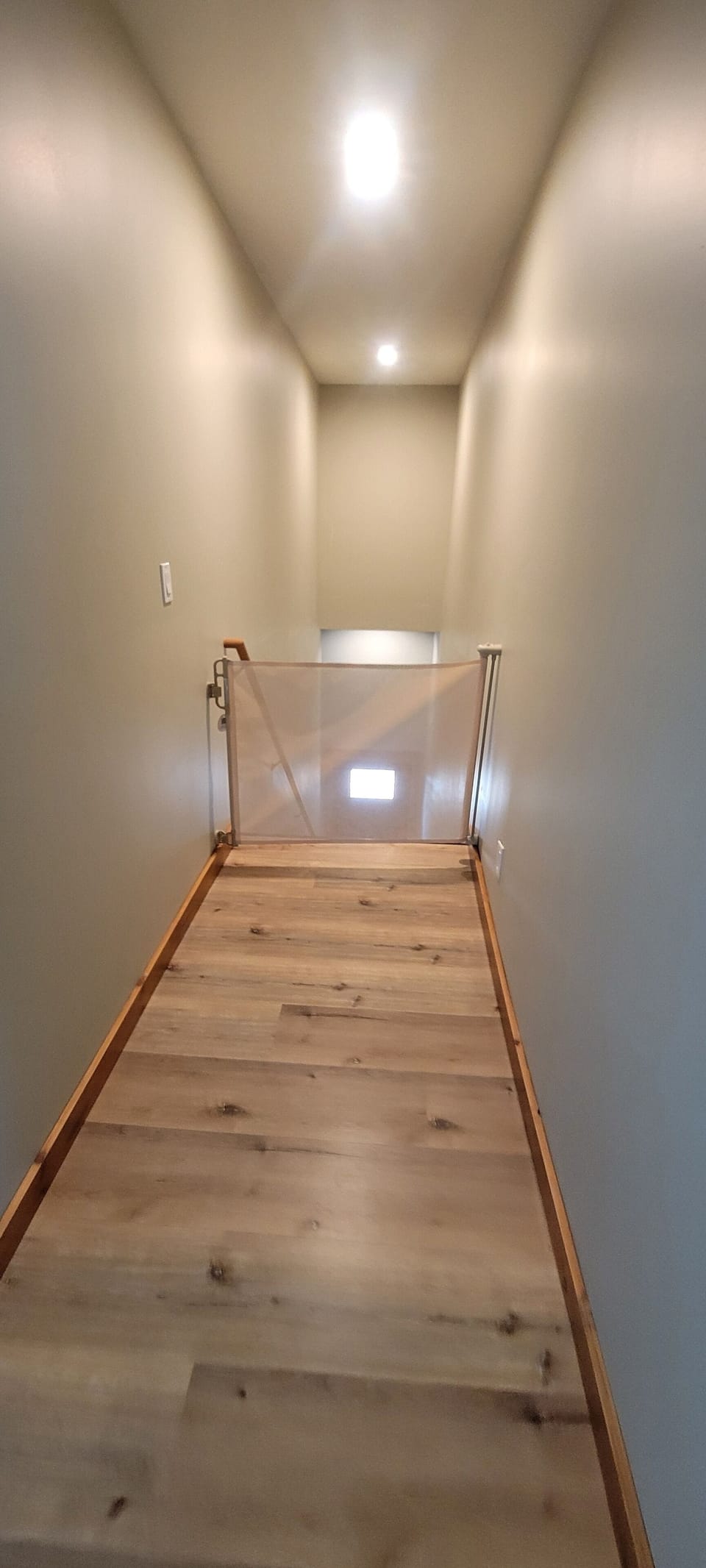 Retractable baby gate at the top of the stairs