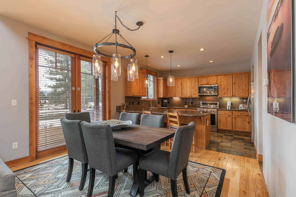 Dining table offers seating for six with additional seats at the breakfast bar.