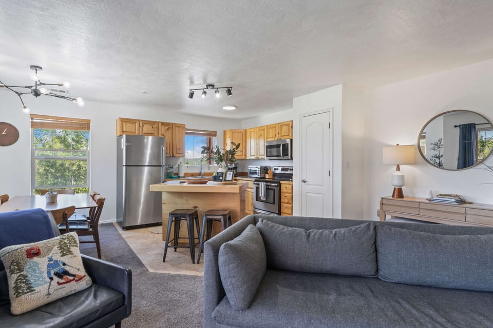 Cozy living space with kitchen on background