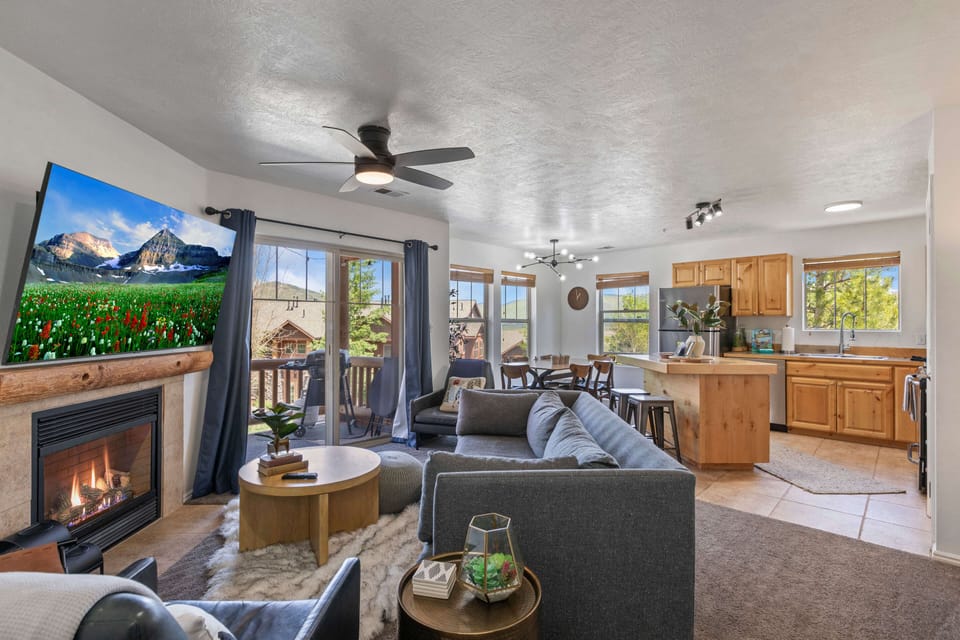 Cozy sofa, fireplace and TV with large window view