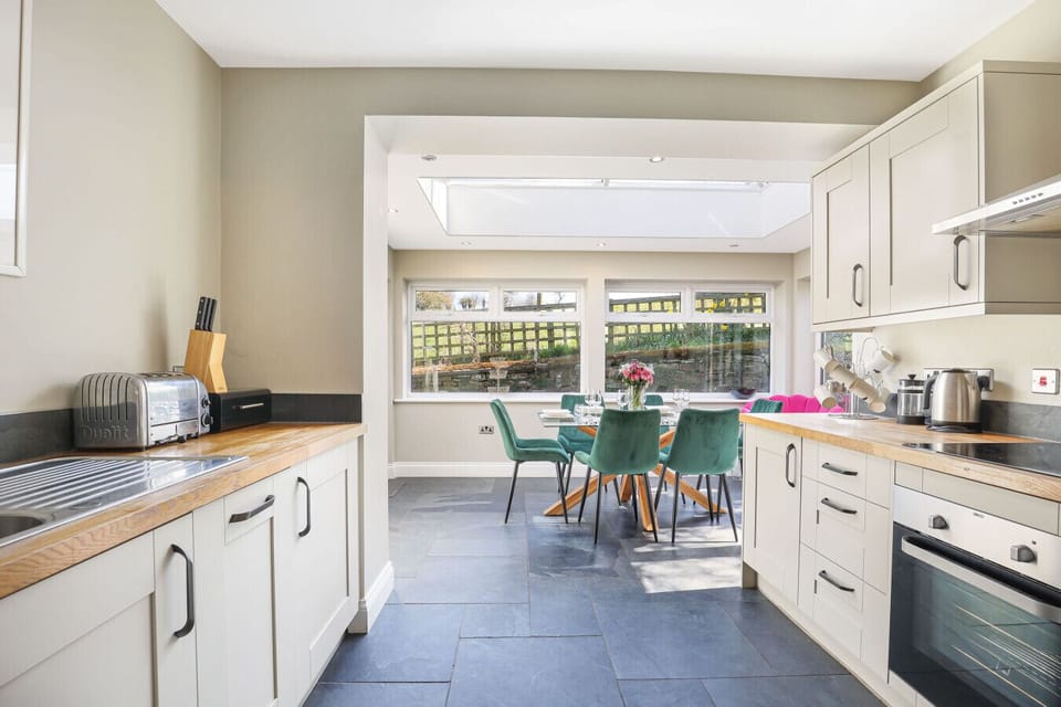 Galley kitchen opening into the bright dining area