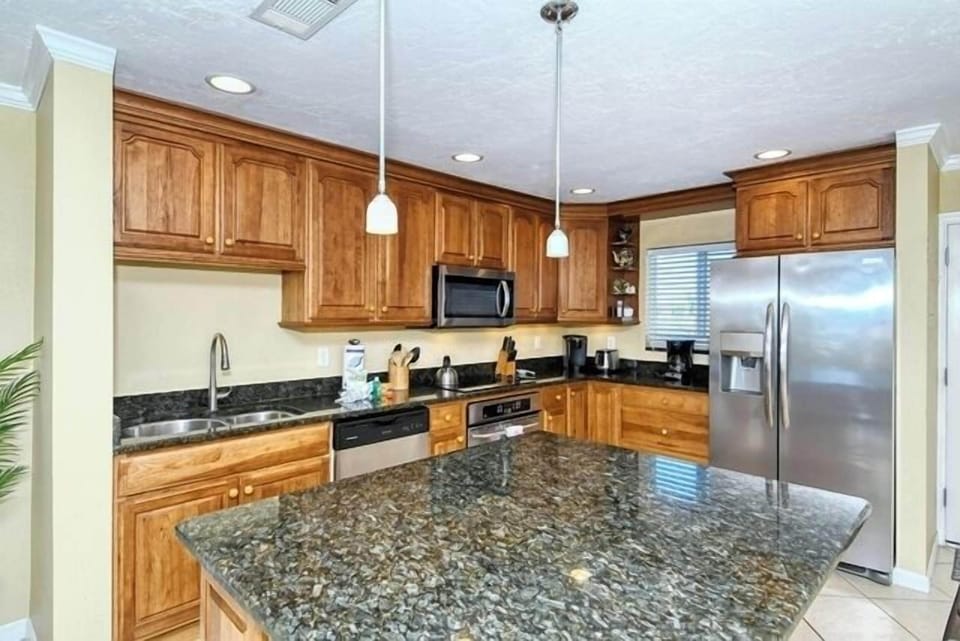 Kitchen Area - Stainless steel appliances and granite countertops.