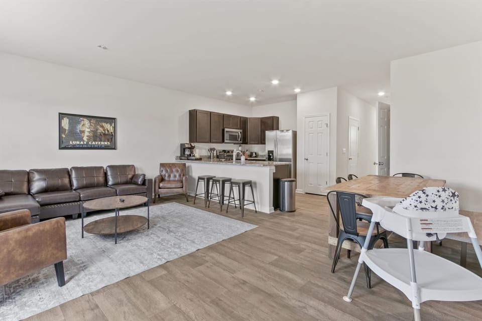 Living Room: Bright and airy space with stylish leather seating and timeless decor!
