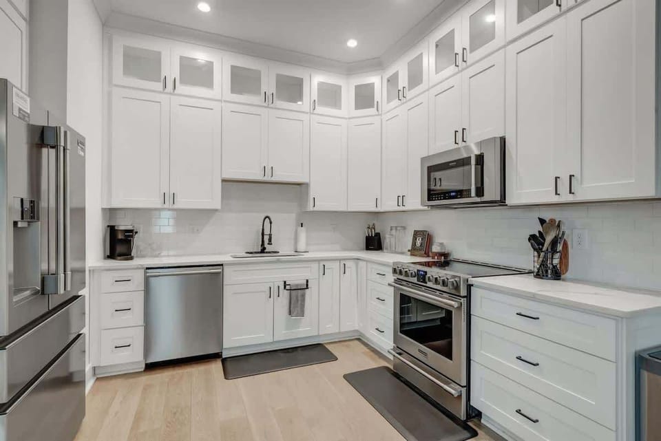 Elegant light-filled kitchen featuring stainless steel appliances and a spacious layout for effortless cooking and entertaining.