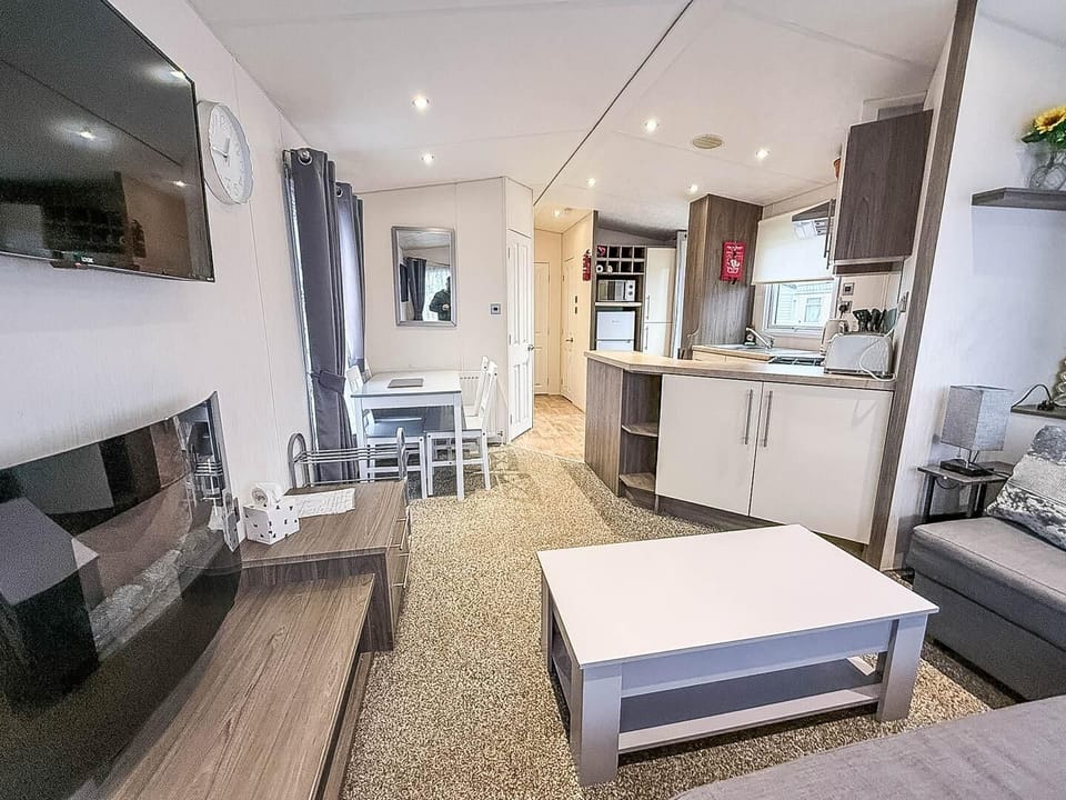 The living area is perfect for relaxing, with a dining table and comfortable seating.