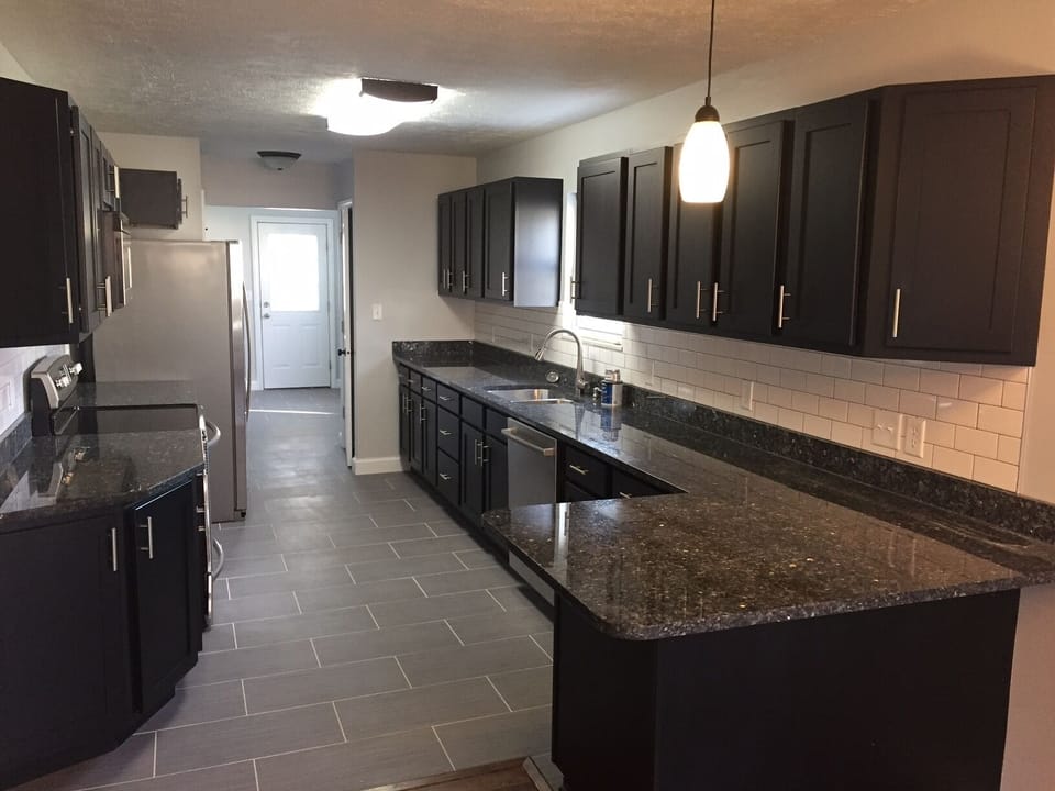 Huge Kitchen with porcelain tile floors and Breakfast bar