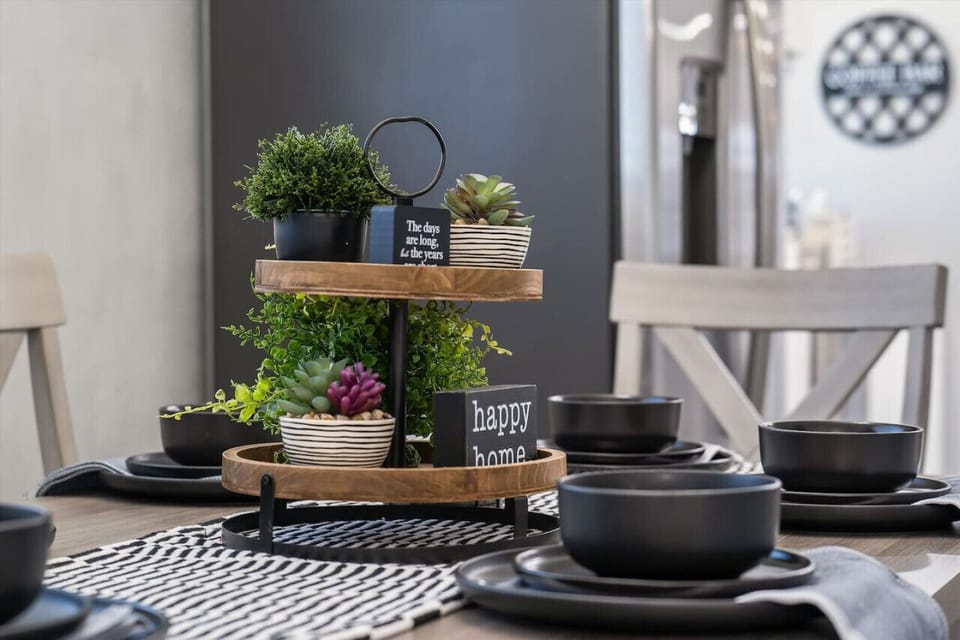 Styled kitchen shelf w/ plants, cookware & thoughtful touches that add warmth to the space.