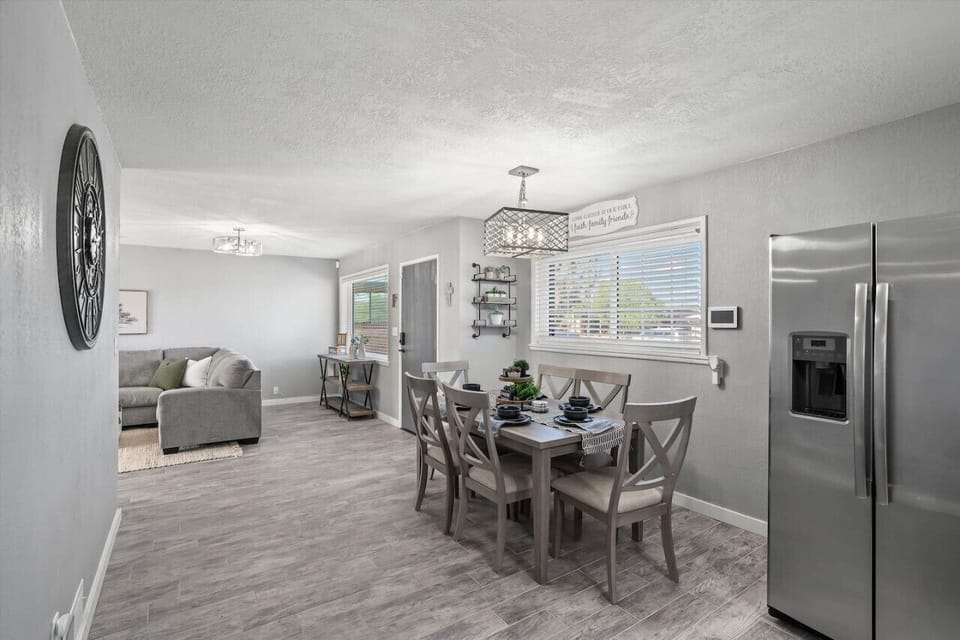 Open dining area w/ modern table set beside the kitchen, ideal for shared meals & conversation.