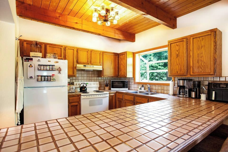 The kitchen features spices & oils, a drip coffee maker, coffee grinder, toaster oven, air fryer & more! 