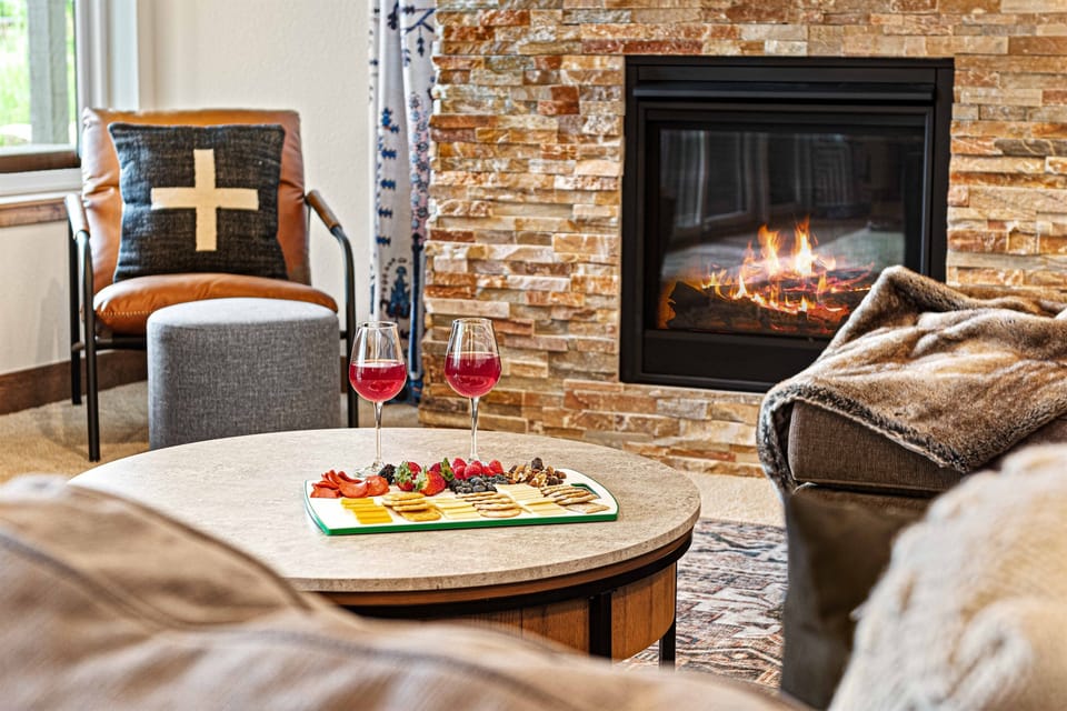 The lower level living room is the perfect spot to sit by the fireplace with a good book